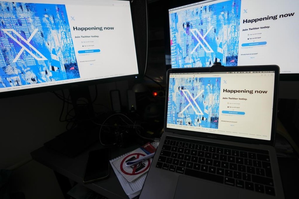 FILE - Computer monitors and a laptop display the X, formerly known as Twitter, sign-in page, July 24, 2023, in Belgrade, Serbia. X's engineering team said it would be “making Likes private for everyone to better protect your privacy