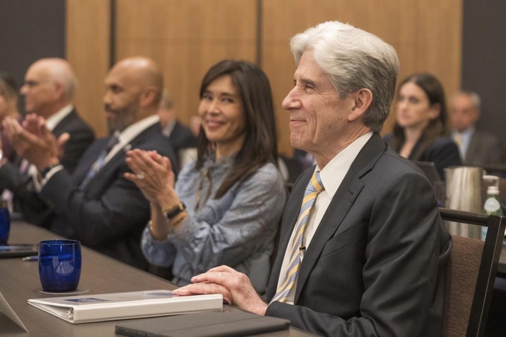 Dr. Julio Frenk, right, smiles as he is confirmed as the next chancellor of the University of California, Los Angeles, UCLA, during a meeting of the regents of the University of California system Wednesday, June 12, 2024, on the UCLA campus in Los Angeles. Darnell Hunt, executive vice president and provost, seen second from left, will serve as interim chancellor until Frenk becomes UCLA's seventh chancellor on Jan. 1, 2025. (AP Photo/Damian Dovarganes)