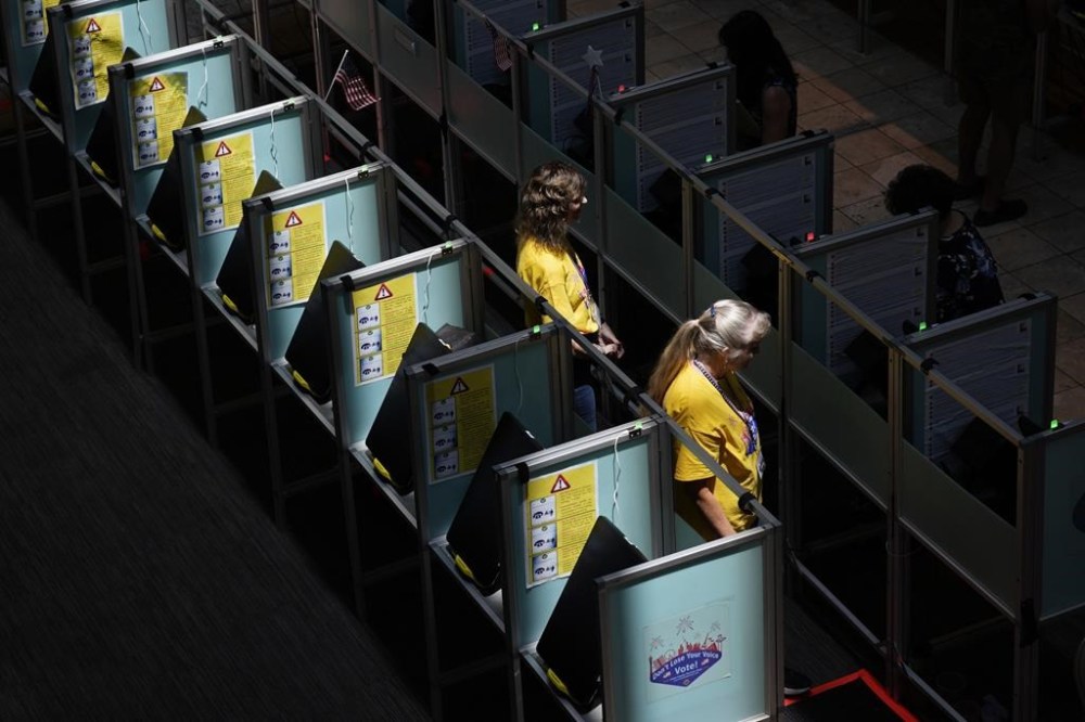 Poll workers in help people vote in the Nevada primary at a polling place, Tuesday, June 11, 2024, in Henderson, Nev. (AP Photo/John Locher)