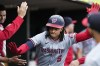 Washington Nationals' CJ Abrams is greeted in the dugout after his solo home run during the third inning of a baseball game against the Detroit Tigers, Wednesday, June 12, 2024, in Detroit. (AP Photo/Carlos Osorio)