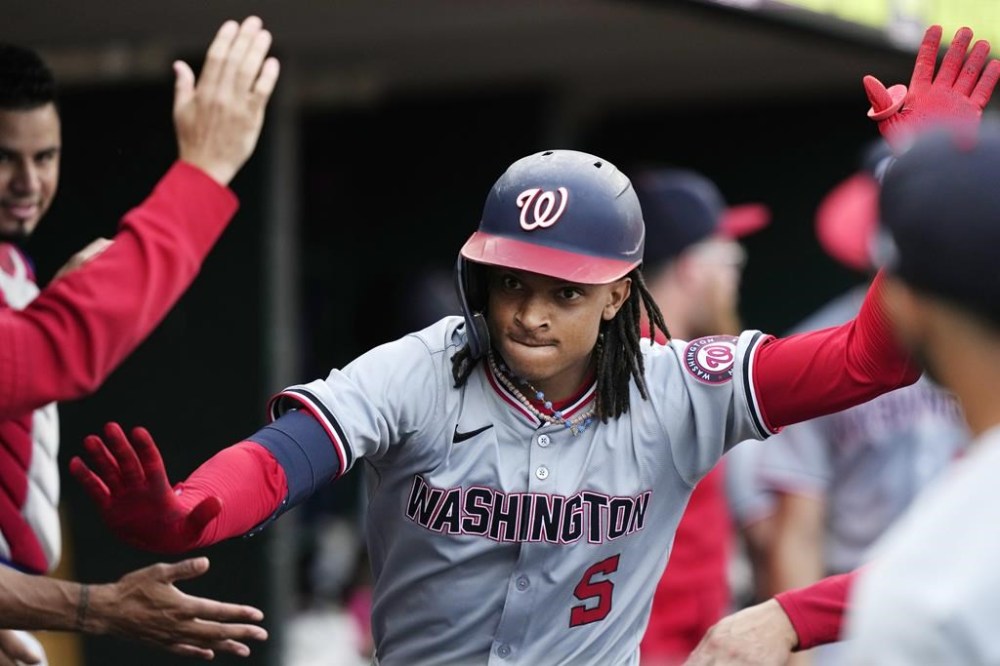 Washington Nationals' CJ Abrams is greeted in the dugout after his solo home run during the third inning of a baseball game against the Detroit Tigers, Wednesday, June 12, 2024, in Detroit. (AP Photo/Carlos Osorio)