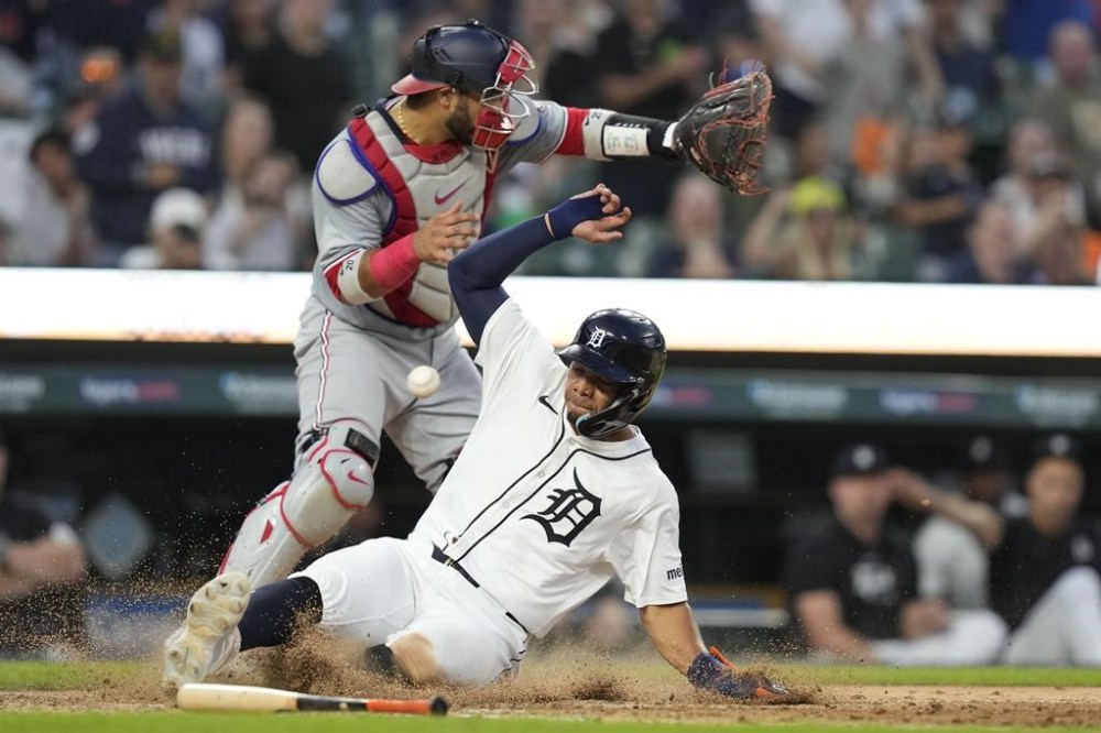 Detroit Tigers' Wenceel Perez beats the throw to Washington Nationals catcher Keibert Ruiz to scores from second on a fielding error by left fielder Jesse Winker during the eighth inning of a baseball game, Wednesday, June 12, 2024, in Detroit. (AP Photo/Carlos Osorio)