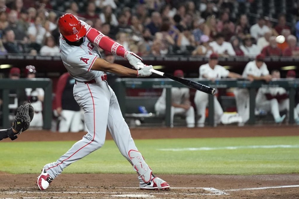 Los Angeles Angels' Jo Adell connects for a three-run home run against the Arizona Diamondbacks during the fourth inning of a baseball game, Wednesday, June 12, 2024, in Phoenix. (AP Photo/Ross D. Franklin)
