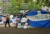 A person walks past the pro-Palestinian encampment on the McGill University campus in Montreal on May 13, 2024. Members of a pro-Palestinian encampment who have been camping on McGill University's downtown campus since April say the school's latest offer falls far short of what's needed to get them to leave. THE CANADIAN PRESS/Ryan Remiorz