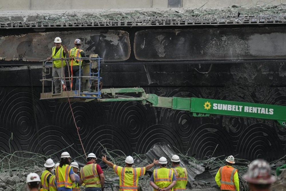 FILE - Crews work at the site of a collapsed section of Interstate 95 in Philadelphia, June 14, 2023. A new report, made public on Wednesday, June 12, 2024, by the Bureau of Alcohol, Tobacco, Firearms and Explosives, details the events leading up to the crash of the gasoline delivery truck that ultimately destroyed the bridge. (AP Photo/Matt Rourke, File)