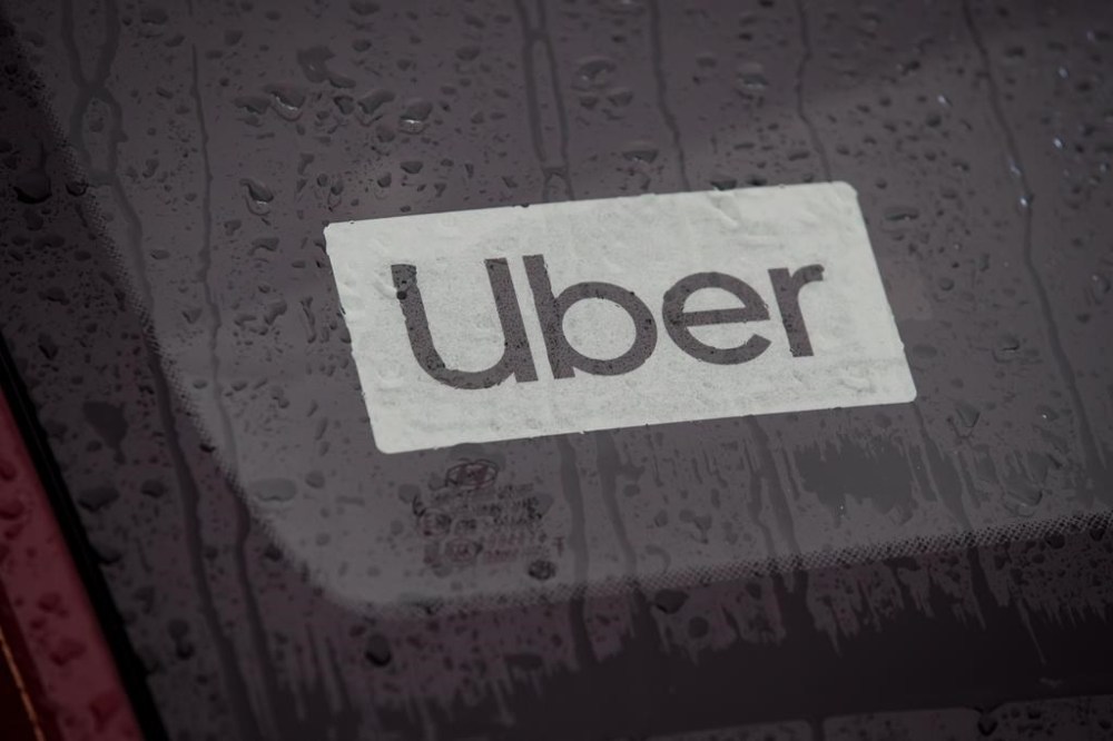 An Uber driver's vehicle is seen after the company launched service, in Vancouver, Friday, Jan. 24, 2020. Uber says changes coming to the laws surrounding British Columbia ride-share and delivery workers will drive up costs and reduce demands for local restaurants. THE CANADIAN PRESS/Darryl Dyck