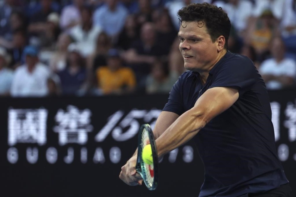 Milos Raonic of Canada plays a backhand return to Alex de Minaur of Australia during their first round match at the Australian Open tennis championships at Melbourne Park, Melbourne, Australia, Monday, Jan. 15, 2024. Raonic advanced to the men's quarterfinals at the Libema Open grass-court tennis tournament with a 4-6, 6-2, 7-5 win over Spain's Roberto Bautista Agut on Thursday. THE CANADIAN PRESS/AP-Asanka Brendon Ratnayake)