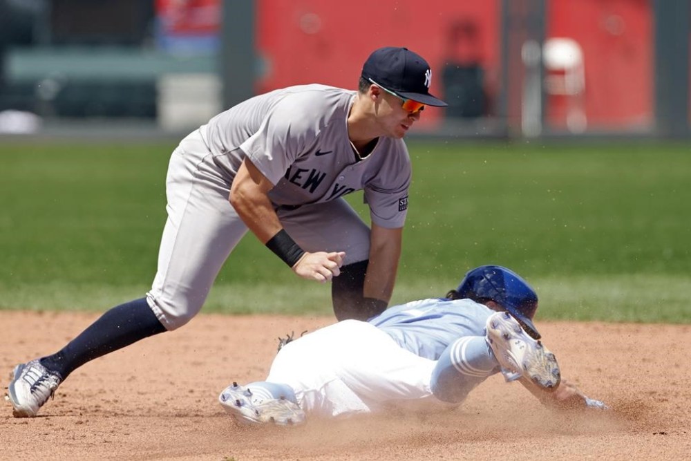 New York Yankees shortstop Anthony Volpe, left, tags out Kansas City Royals' Bobby Witt Jr., right, as he attempts to steal second base during the sixth inning of a baseball game in Kansas City, Mo., Thursday, June 13, 2024. (AP Photo/Colin E. Braley)