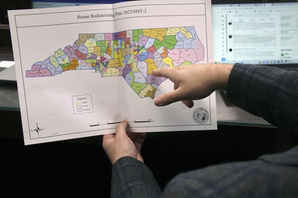 FILE - The North Carolina state House reviews copies of a map proposal for new state House districts during a committee hearing at the Legislative Office Building in Raleigh, N.C., Thursday, Oct. 19, 2023. North Carolina judges deciding whether a redistricting lawsuit claiming a state constitutional right to “fair
