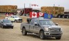 Anti-mandate demonstrators gather as a truck convoy blocks the highway the busy U.S. border crossing in Coutts, Alta., Monday, Jan. 31, 2022. A second RCMP officer who went undercover as a supporter at the Coutts, Alta., blockade in 2022 has testified that one of two men charged with conspiracy to commit murder said all police officers at the blockade 