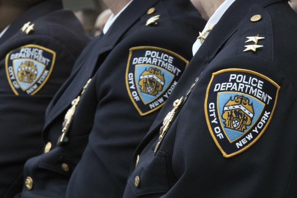 FILE - Members of the New York City Police Department listen to a news conference, Jan. 4, 2017, in New York. Paul Zangrilli, a high-ranking NYPD official lied to fellow law enforcement and tried to get incriminating video footage erased after his girlfriend crashed his police car. (AP Photo/Mary Altaffer, File)