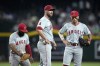 Los Angeles Angels relief pitcher Hunter Strickland, center, pauses on the mound as he is flanked by third baseman Luis Rengifo, left, and shortstop Zach Neto as Angels manager Ron Washington walks to the mound to replace Strickland during the seventh inning of the team's baseball game against the Arizona Diamondbacks, Thursday, June 13, 2024, in Phoenix. (AP Photo/Ross D. Franklin)