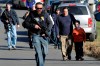 FILE - Parents leave a staging area after being reunited with their children following a shooting at the Sandy Hook Elementary School in Newtown, Conn., where authorities say a gunman opened fire, Dec. 14, 2012. Right-wing conspiracy theorist Alex Jones appears on the brink of losing the Infowars media platform that he turned into a multimillion-dollar moneymaker, as a bankruptcy judge is set to rule, Friday, June 14, 2024, whether to liquidate his assets to help pay the $1.5 billion he owes for his false claims that the Sandy Hook Elementary School shooting was a hoax. (AP Photo/Jessica Hill, File)