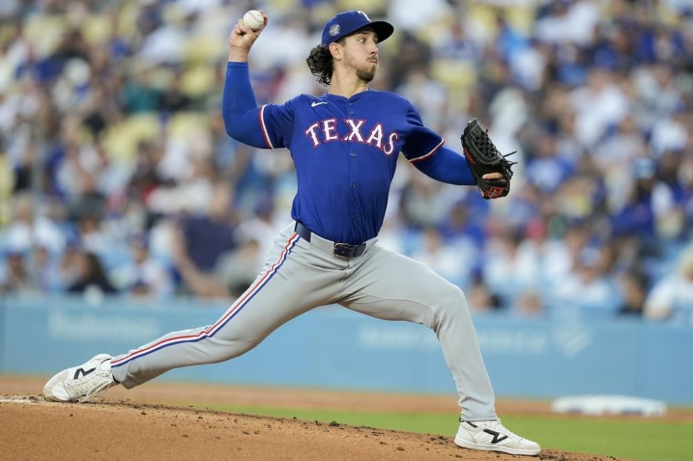 Texas Rangers starting pitcher Michael Lorenzen throws during the first inning of a baseball game against the Los Angeles Dodgers, Thursday, June 13, 2024, in Los Angeles. (AP Photo/Ryan Sun)