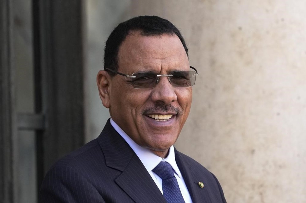 FILE - Niger's President Mohamed Bazoum smiles before a working lunch with French President Emmanuel Macron, Feb. 16, 2023 at the Elysee Palace in Paris. Niger’s highest court lifted the immunity of the country’s democratically elected president, Mohamed Bazoum, nearly a year after he was overthrown by mutinous soldiers, his lawyer said Friday, June 14, 2024, opening the door for the military junta to prosecute him for alleged high treason. (AP Photo/Michel Euler, File)