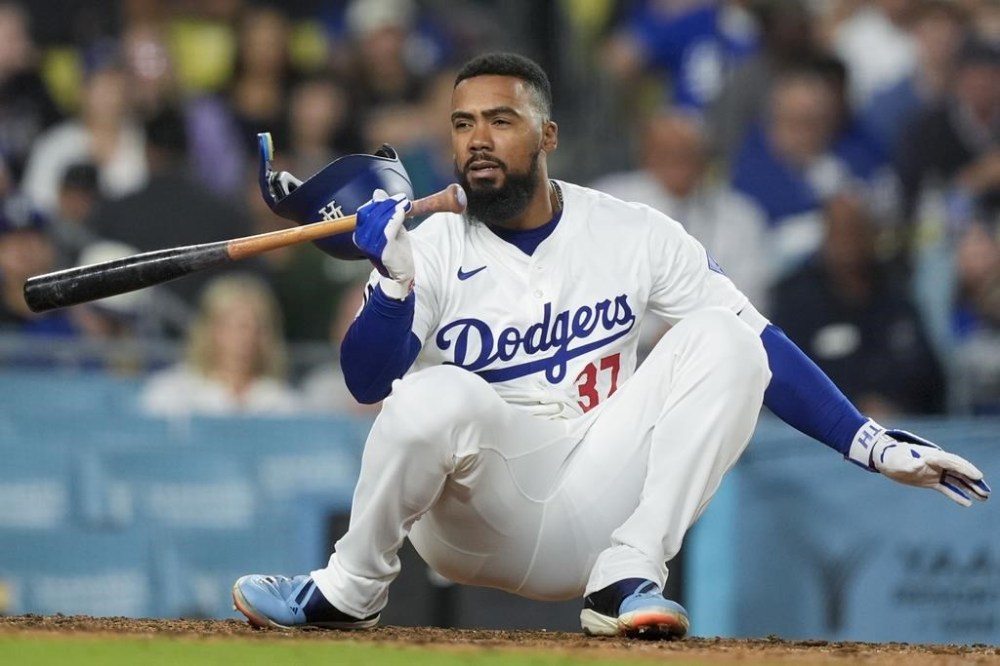 Los Angeles Dodgers' Teoscar Hernandez reacts to a wild pitch from the Texas Rangers during the ninth inning of a baseball game Thursday, June 13, 2024, in Los Angeles. (AP Photo/Ryan Sun)