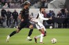 Los Angeles FC midfielder Timothy Tillman, left, pulls the jersey of FC Dallas forward Jesús Ferreira during the second half of a Major League Soccer match Saturday, June 1, 2024, in Los Angeles. (AP Photo/Mark J. Terrill)