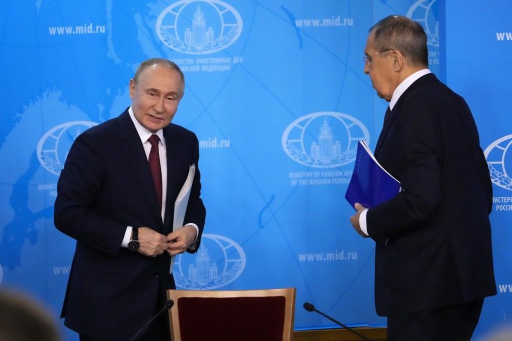 Russian President Vladimir Putin, left, and Russian Foreign Minister Sergey Lavrov leave a meeting at the Russian Foreign Ministry in Moscow, Russia, Friday, June 14, 2024. (AP Photo/Alexander Zemlianichenko)