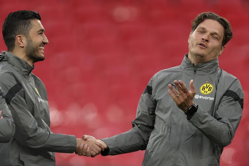 FILE - Dortmund's head coach Edin Terzic, right, and assistant coach Nuri Sahin shake hands during a training session ahead of the Champions League final soccer match between Borussia Dortmund and Real Madrid at Wembley Stadium in London, on May 31, 2024. Borussia Dortmund appointed former player Nuri Sahin as coach on Friday June 14, 2024 to replace Edin Terzić, who quit the club the day before. (AP Photo/Ian Walton, File)