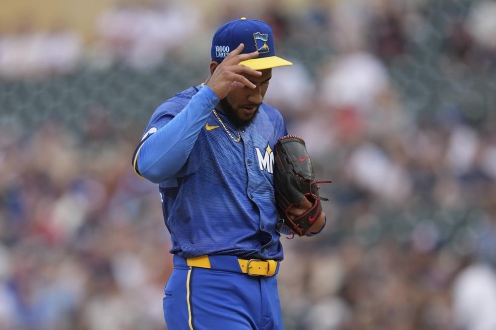 Minnesota Twins starting pitcher Simeon Woods Richardson reacts after a grand slam by Oakland Athletics' Shea Langeliers during the first inning of a baseball game Friday, June 14, 2024, in Minneapolis. (AP Photo/Abbie Parr)