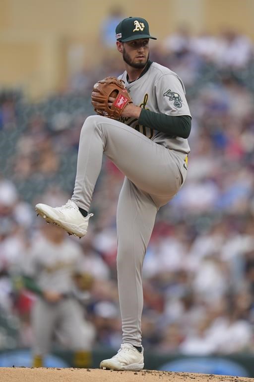 Oakland Athletics starting pitcher Mitch Spence winds up to deliver to a Minnesota Twins batter during the first inning of a baseball game Friday, June 14, 2024, in Minneapolis. (AP Photo/Abbie Parr)