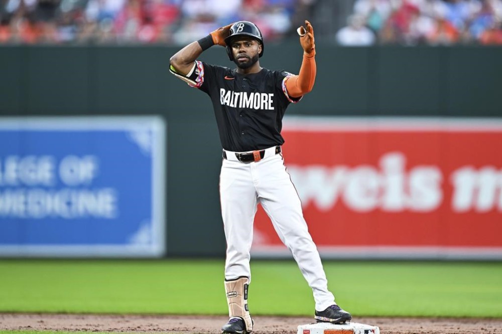 Baltimore Orioles' Cedric Mullins gestures to his dugout after hitting a double against Philadelphia Phillies pitcher Ranger Suárez during the third inning of a baseball game, Friday, June 14, 2024, in Baltimore. (AP Photo/Terrance Williams)