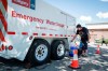 Liz Workun fills water jugs from an emergency supply provided by the city as work to repair a major water main stretches into a second day in Calgary, Friday, June 7, 2024.Calgary has just declared a state of emergency over the water main break. THE CANADIAN PRESS/Jeff McIntosh