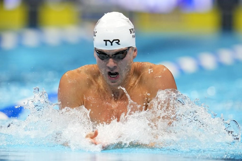 Nic Fink swims during the Men's 100 breaststroke preliminaries Saturday, June 15, 2024, at the US Swimming Olympic Trials in Indianapoils. (AP Photo/Michael Conroy)