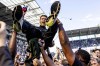 FILE - St. Pauli coach Fabian Hurzeler is lifted by fans who invaded the field after their team won 3-1 during a second division, Bundesliga, soccer match between FC St. Pauli and VfL Osnabrueck, at the Millerntor Stadium, in Hamburg, Germany, on May 12, 2024. Texas-born Fabian Hurzeler was appointed Brighton coach on Saturday June 15, 2024 and became the youngest manager in English Premier League history. (Axel Heimken/dpa via AP, File)