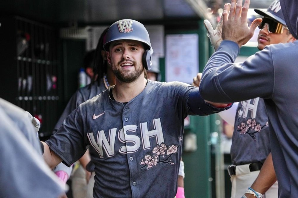 Washington Nationals' Lane Thomas is congratulated by teammates after hitting a home run during the third inning of a baseball game against the Miami Marlins at Nationals Park, Saturday, June 15, 2024, in Washington. (AP Photo/Jacquelyn Martin)