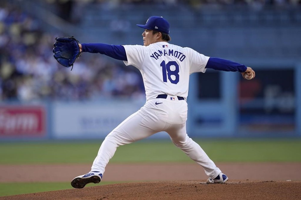 Los Angeles Dodgers starting pitcher Yoshinobu Yamamoto throws to the plate during the first inning of a baseball game against the Kansas City Royals Saturday, June 15, 2024, in Los Angeles. (AP Photo/Mark J. Terrill)