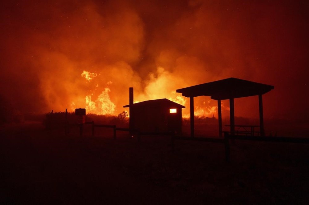 Flames from the Post Fire advance on structures on Saturday, June 15, 2024, in Gorman, Calif. (AP Photo/Eric Thayer)