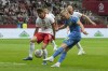 Ukraine's Oleksandr Zinchenko kicks the ball ahead of Poland's Bartosz Bereszynski during the international friendly soccer match between Poland and Ukraine at the National stadium in Warsaw, Poland, Friday, June 7, 2024. (AP Photo/Czarek Sokolowski)