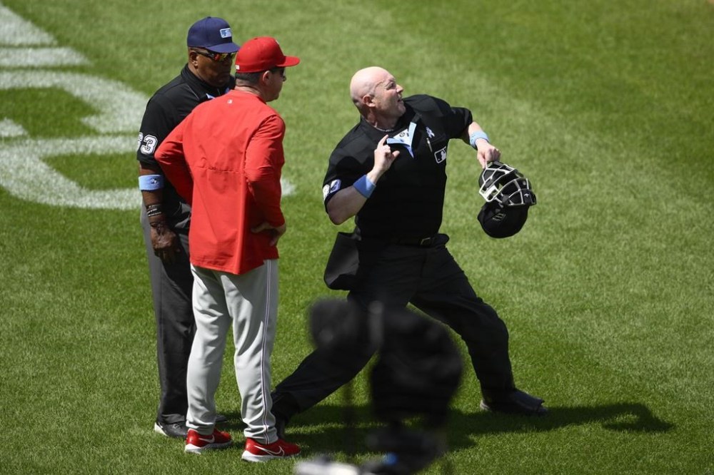 Home plate umpire Mike Estabrook, right, ejects Philadelphia Phillies manager Rob Thomson, left, during the sixth inning of a baseball game, Sunday, June 16, 2024, in Baltimore. Third base umpire Laz Diaz watches at back left. (AP Photo/Nick Wass)