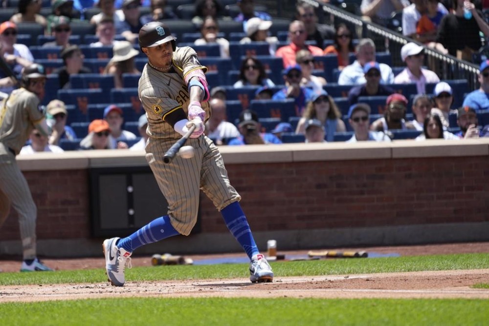 San Diego Padres' Manny Machado hits a single leading to Jurickson Profar scoring during the first inning of a baseball game against the New York Mets, Sunday, June 16, 2024, in New York. (AP Photo/Pamela Smith)