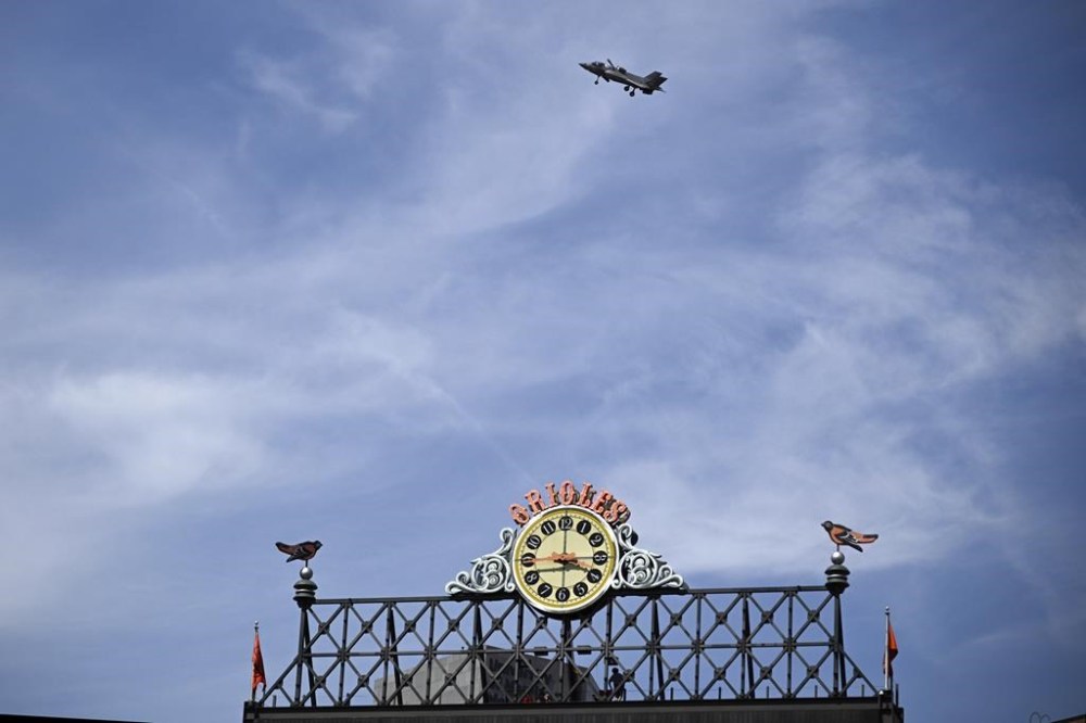 A fighter jet, as part of Maryland Fleet Week and Flyover festivities, flies by Oriole Park at Camden Yards during a baseball game between the Baltimore Orioles and the Philadelphia Phillies, Sunday, June 16, 2024, in Baltimore. (AP Photo/Nick Wass)