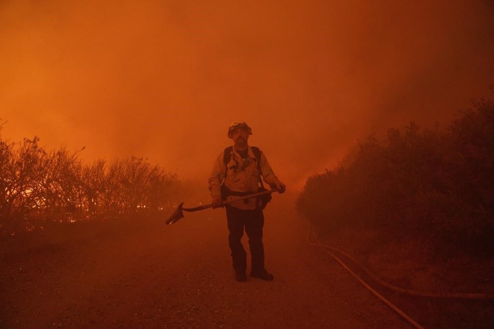 A firefighter watches for advancing flames during the Post Fire on Sunday, June 16, 2024, in Gorman, Calif. (AP Photo/Eric Thayer)