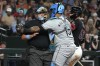 Chicago White Sox catcher Martin Maldonado (15) holds onto MLB umpire Marvin Hudson, left, after Hudson was hit with a foul ball in the sixth inning during a baseball game against the Chicago White Sox, Sunday, June 16, 2024, in Phoenix. Hudson left the game and did not return. (AP Photo/Rick Scuteri)