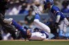 Los Angeles Dodgers' Mookie Betts, left, writhes on the ground after being hit by a pitch as Kansas City Royals catcher Freddy Fermin kneels at the plate during the seventh inning of a baseball game Sunday, June 16, 2024, in Los Angeles. (AP Photo/Mark J. Terrill)