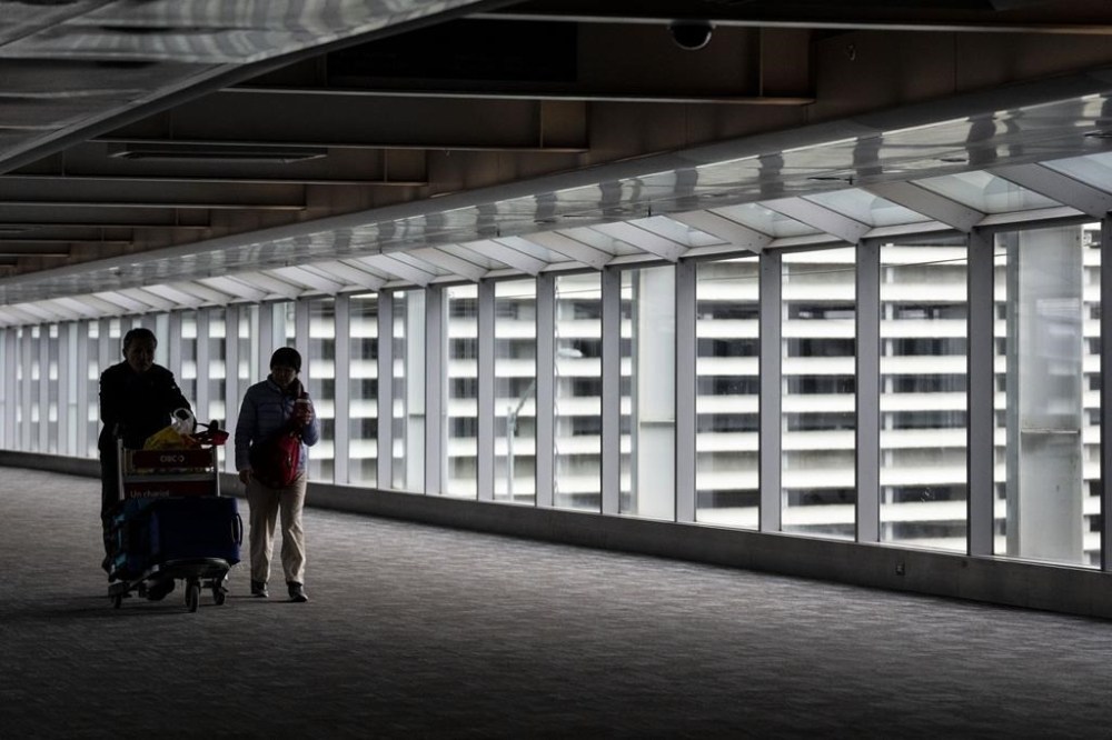 A new report says fares on summer flights to Canadian cities have shot up over the past year. People make their way through Pearson Airport in Mississauga, Ont. on Tuesday, March 14, 2023. THE CANADIAN PRESS/Chris Young