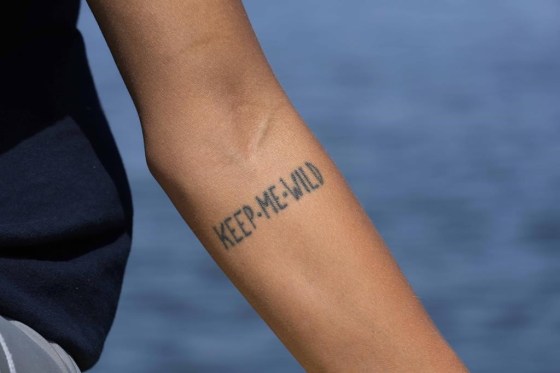 Marine biologist Linda Albonetti displays her tattoo that reads 