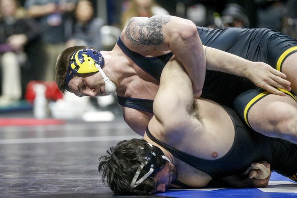 FILE - Michigan's Mason Parris attempts to turn Iowa's Tony Cassioppi during the semifinal round of the NCAA Wrestling Championships in Tulsa, Okla., Friday, March 17, 2023. Parris said years ago, he was dubbed ‘King Parris,’ and it stuck. Soon, he could become the king of the 125-kilogram weight class at the Paris Olympics. (Ian Maule/Tulsa World via AP, File)