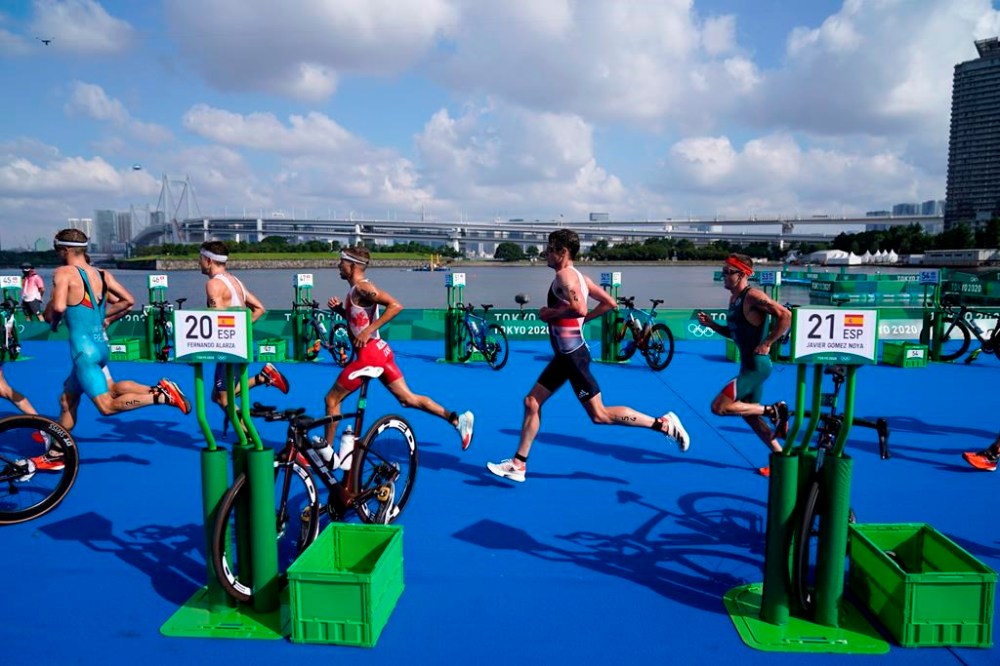 Veteran Tyler Mislawchuk and rookies Emy Legault and Charles Paquet will represent Canada in triathlon in the Olympic Games in Paris. Mislawchuk, center left, runs through the second transition during the men's individual triathlon at the 2020 Summer Olympics, in Tokyo, Monday, July 26, 2021. THE CANADIAN PRESS/AP-David Goldman