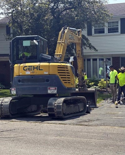 Bidigare Contractors employees work Monday, June 17, 2024, on a water main project in Farmington Hills, Mich., a suburb of Detroit. Workers say they drink lots of water and take frequent breaks when faced with doing their jobs in extreme heat. (AP Photo/Corey Williams)