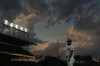 Chicago Cubs first base coach Mike Napoli looks into the stands as a commercial airplane make its way to O'Hare International Airport during the fourth inning of a baseball game against the San Francisco Giants, Monday, June 17, 2024, in Chicago. (AP Photo/Charles Rex Arbogast)
