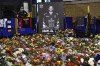 FILE - Flower tributes for Nottingham Panthers player Adam Johnson, who died last year from a skate cut to the neck, rest outside the Motorpoint Arena before a memorial ice hockey game between the Panthers and the Manchester Storm in Nottingham, England, Nov. 18, 2023. A Minnesota youth hockey camp is honoring the life of late alum Johnson with a scholarship in his honor. (AP Photo/Rui Vieira, File)