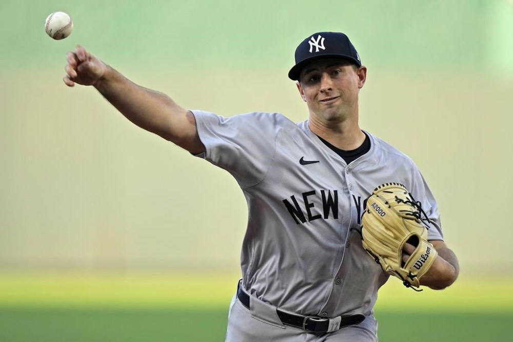 New York Yankees starting pitcher Cody Poteet throws during the first inning of a baseball game against the Kansas City Royals Wednesday, June 12, 2024, in Kansas City, Mo. (AP Photo/Charlie Riedel)