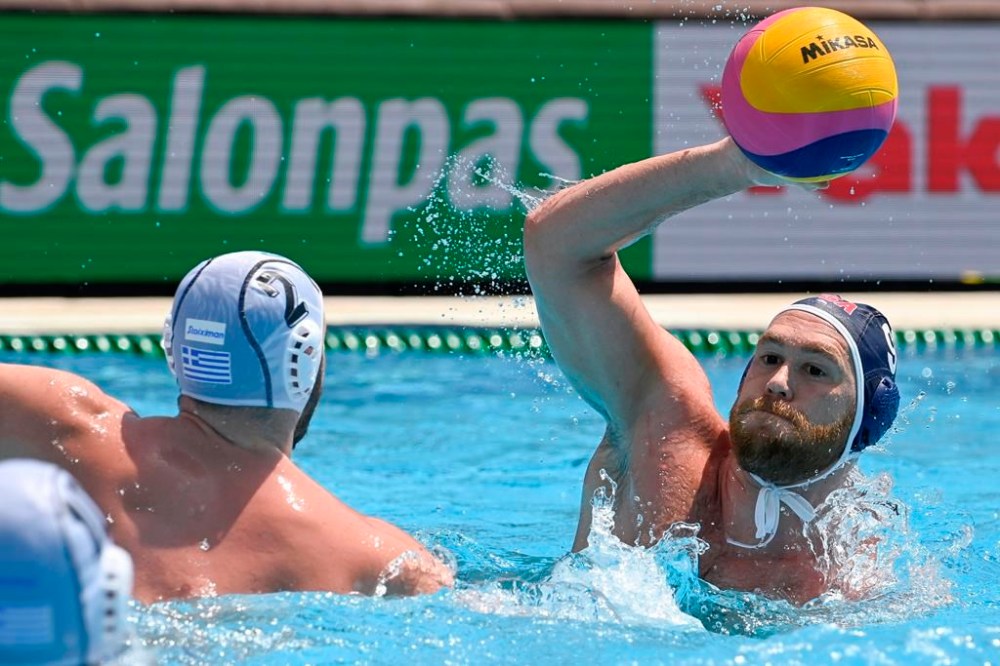 CORRECTS ID AT RIGHT TO ALEX BOWEN, NOT BEN HALLOCK- FILE- Konstantinos Genidounias, left, of Greece defends against Alex Bowen of the US during men's water polo quarterfinal match Greece vs. US at 19th FINA World Aquatics Championships in Hajos Alfred National Sports Swimming Pool in Budapest, Hungary, Wednesday, June 29, 2022. Bowen was selected for the U.S. men's water polo team on Tuesday, June 18, 2024. (Szilard Koszticsak/MTI via AP, File)