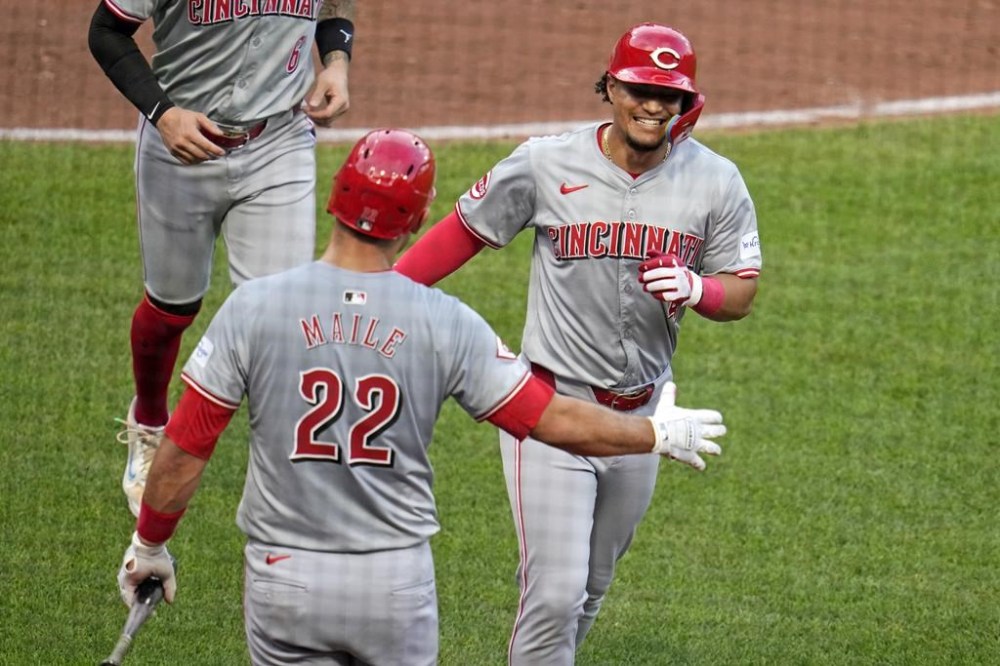 Cincinnati Reds' Santiago Espinal, right, celebrates with Luke Maile (22) as he returns to the dugout after hitting a two-run home run off Pittsburgh Pirates starting pitcher Bailey Falter during the fifth inning of a baseball game in Pittsburgh, Tuesday, June 18, 2024. (AP Photo/Gene J. Puskar)