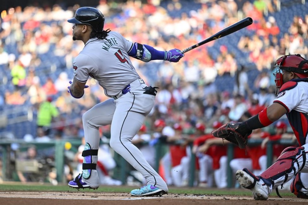 Arizona Diamondbacks' Ketel Marte watches his two-run home run next to Washington Nationals catcher Keibert Ruiz during the first inning of a baseball game Tuesday, June 18, 2024, in Washington. (AP Photo/John McDonnell)
